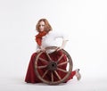 Young woman with an old wagon wheel Royalty Free Stock Photo