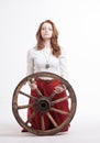 Young woman with an old wagon wheel Royalty Free Stock Photo