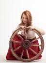 Young woman with an old wagon wheel Royalty Free Stock Photo