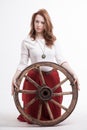 Young woman with an old wagon wheel Royalty Free Stock Photo