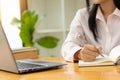 Young woman online job hunting working with laptop computer, blank screen