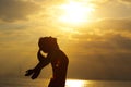 young woman open arms on sunrise beach Royalty Free Stock Photo