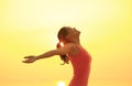 young woman open arms on sunrise beach Royalty Free Stock Photo