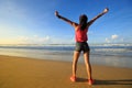 Young woman open arms on sunrise seaside beach Royalty Free Stock Photo