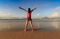young woman open arms on sunrise seaside beach Royalty Free Stock Photo