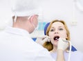 Young woman with open mouth during drilling treatm Royalty Free Stock Photo