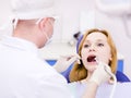 Young woman with open mouth during drilling treatm