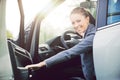 Young woman opening car door Royalty Free Stock Photo