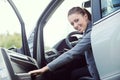 Young woman opening car door Royalty Free Stock Photo