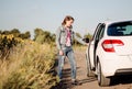 Young woman opening a car door Royalty Free Stock Photo