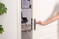 Young woman opening door to beautifully arranged room