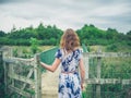 Young woman opening gate in the country Royalty Free Stock Photo