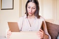 Young woman opening packet at home