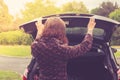 Young woman opening trunk of car Royalty Free Stock Photo