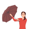 Young woman opening umbrella in rain. Autumn or spring season, rainy windy weather