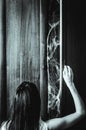 Young woman opens a door of an old wardrobe with spiderweb something creepy inside Royalty Free Stock Photo