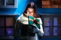 Young woman opens her gift Christmas in a magical atmosphere Royalty Free Stock Photo