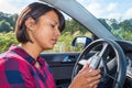Young woman operates electronic route planner in car