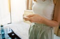 Young woman operates wireless security system in a modern apartment.