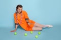 Trendy girl with tennis balls on blue Royalty Free Stock Photo