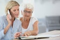 Young woman organising appointments for senior woman