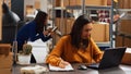 Young woman organizing merchandise in piles Royalty Free Stock Photo