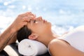 Young woman at osteopathic treatment session outdoors.