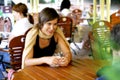 Young woman at outdoor coffee shop Royalty Free Stock Photo