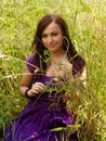 Young woman outdoor in the grass in summertime