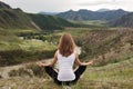 Young Woman Outdoor Meditation. Sitting on the Mountain.