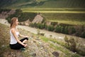 Young Woman Outdoor Meditation. Sitting on the Mountain.