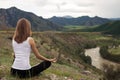 Young Woman Outdoor Meditation. Sitting on the Mountain.