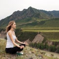 Young Woman Outdoor Meditation. Sitting on the Mountain.