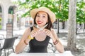 Young woman in outdoor restaurant with a knife and fork in her hands Royalty Free Stock Photo