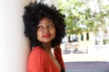 Young woman outside leaning against wall daydreaming Royalty Free Stock Photo