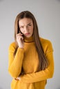 Young woman  over grey wall background talking by mobile phone Royalty Free Stock Photo