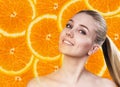 Young woman over orange fruit slices background. Royalty Free Stock Photo