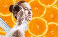 Young woman over orange fruit slices background. Royalty Free Stock Photo