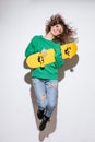 Young woman over white background with skateboard jumping. Royalty Free Stock Photo