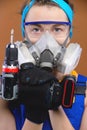young woman in overalls and a respirator with a screwdriver in her hands stands Royalty Free Stock Photo