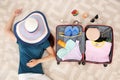 Young woman packing suitcase for summer journey at home Royalty Free Stock Photo