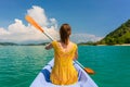 Young woman paddling a canoe during vacation in Flores Island Royalty Free Stock Photo