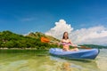 Young woman paddling during vacation in an idyllic travel destin Royalty Free Stock Photo