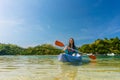 Young woman paddling during vacation in an idyllic travel destination Royalty Free Stock Photo