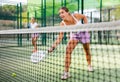 Young woman padel tennis player trains on the outdoor court Royalty Free Stock Photo