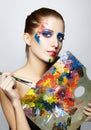 Young woman painter with color palette and paint brush Royalty Free Stock Photo