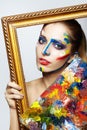 Young woman painter in golden frame with color pallet Royalty Free Stock Photo
