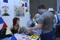 Young woman painter presenting her paintings to a man