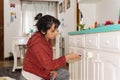 Young woman painting furniture at home Royalty Free Stock Photo