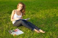 Young woman painting on a green meadow Royalty Free Stock Photo